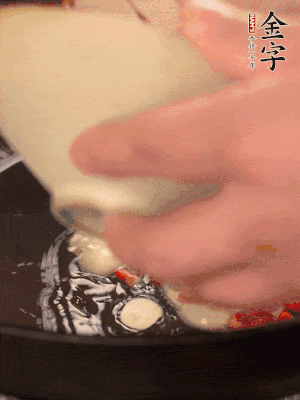 豬油潤(rùn)鍋，下辣椒、大蒜、火腿片煸香。